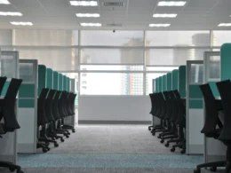 Empty black rolling chairs at office cubicles
