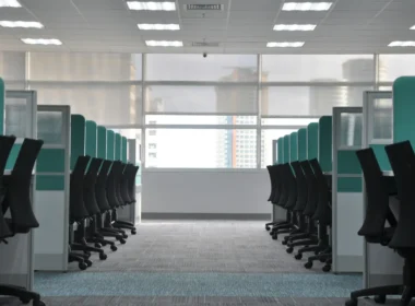Empty black rolling chairs at office cubicles