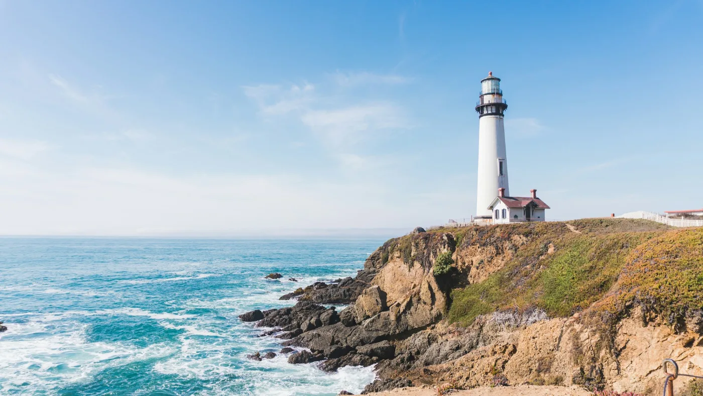 Lighthouse on a mountain beside the ocean