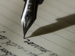 Fountain pen on black lined paper