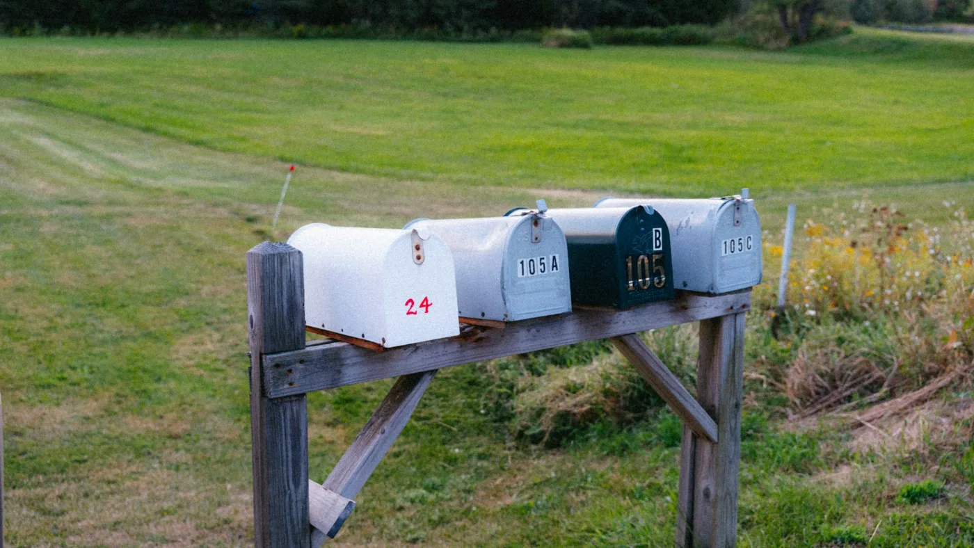 Four mailboxes standing in a row on a wooden post