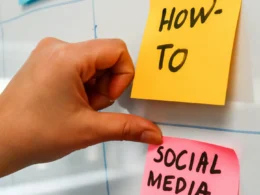 A hand pointing to sticky notes on a bulletin board