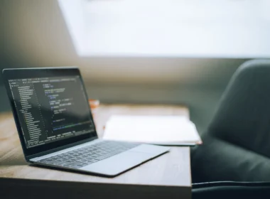 Laptop showing code in a bright office, where a team weighs Muse Wonder pricing against its current model