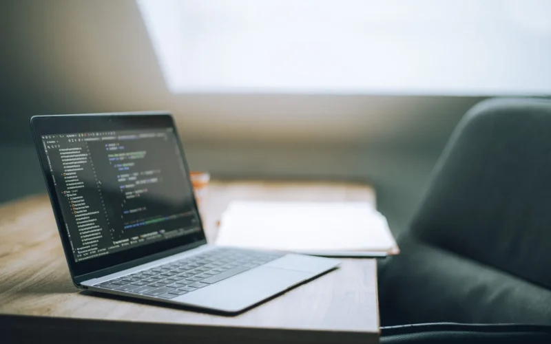 Laptop showing code in a bright office, where a team weighs Muse Wonder pricing against its current model