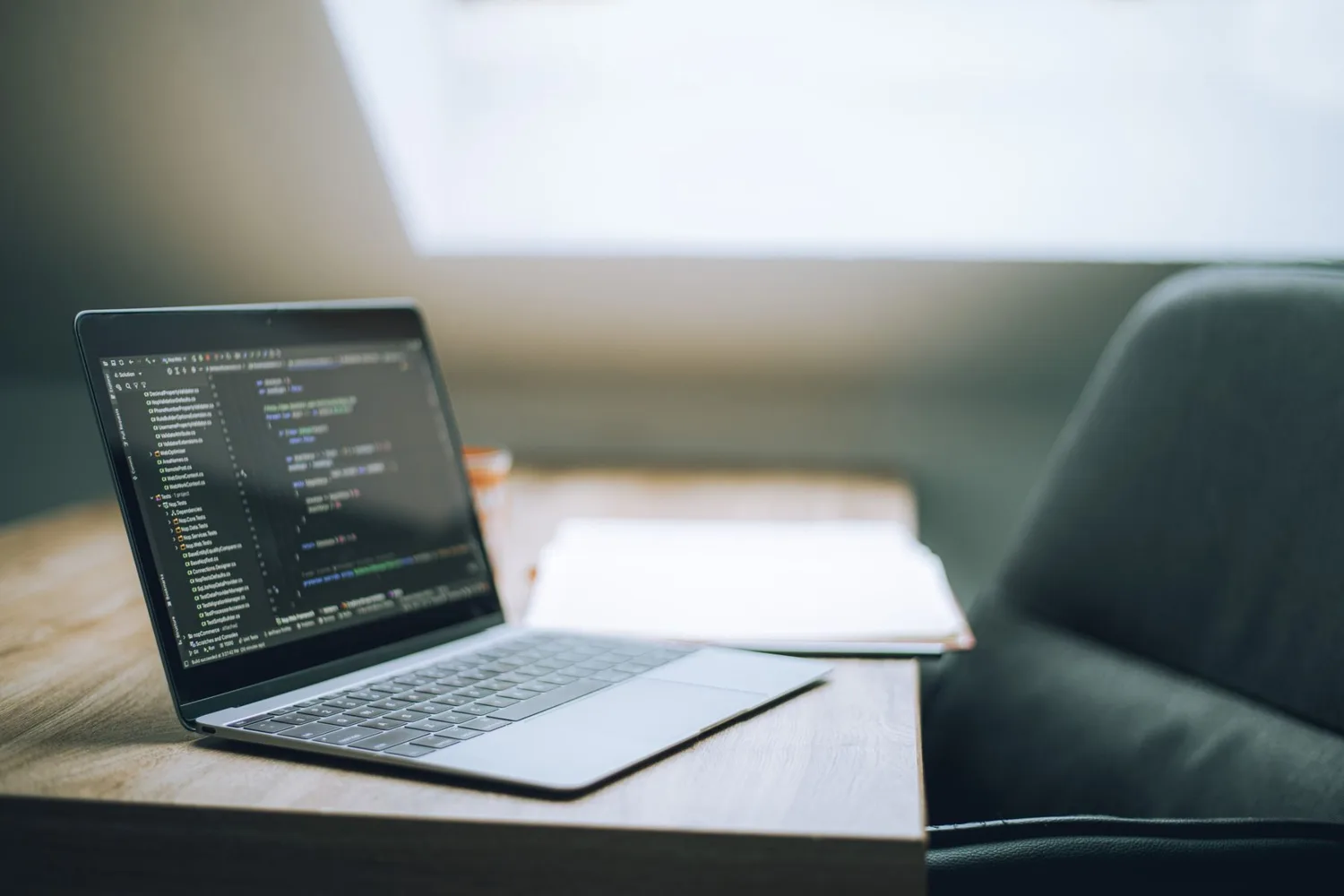 Laptop showing code in a bright office, where a team weighs Muse Wonder pricing against its current model