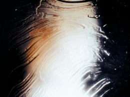 Light falling across a textured glass surface, an abstract stand-in for Claude conversation monitoring