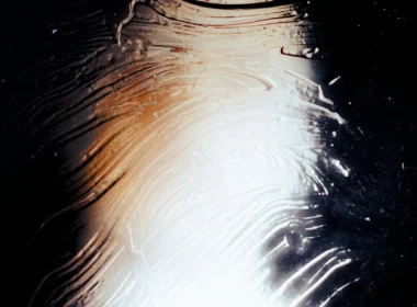 Light falling across a textured glass surface, an abstract stand-in for Claude conversation monitoring