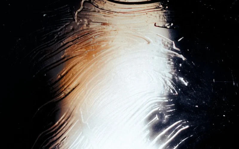 Light falling across a textured glass surface, an abstract stand-in for Claude conversation monitoring