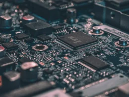 Macro photograph of a black circuit board with electronic chips