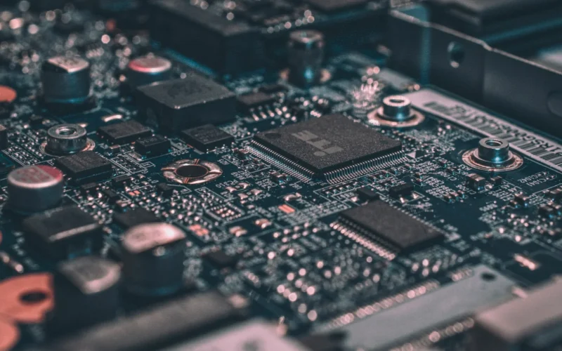 Macro photograph of a black circuit board with electronic chips