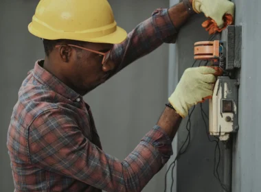 Man in a plaid shirt and yellow hard hat
