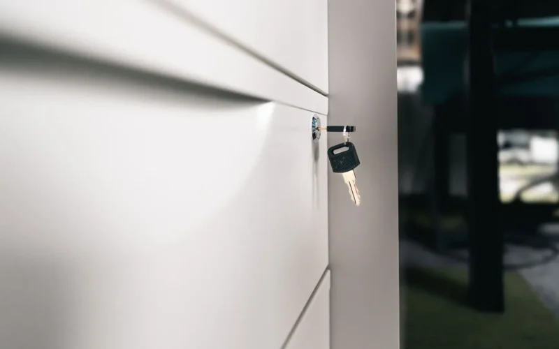 Key left in a locked office cabinet, a reminder to secure files under Alberta's deepfake law