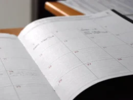 Open monthly planner on wooden desk