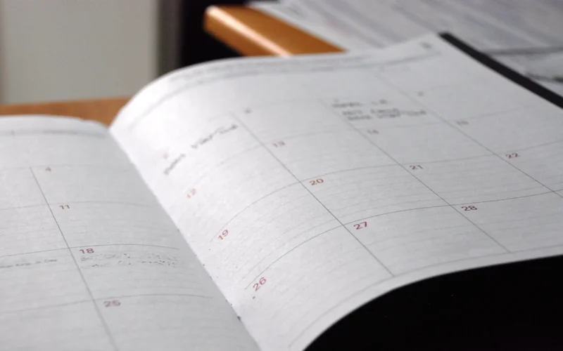 Open monthly planner on wooden desk