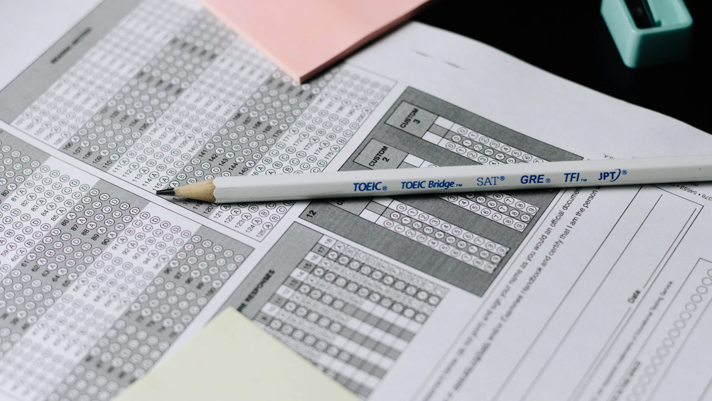 Pencil resting on a filled-in multiple choice answer sheet