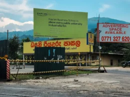 Roadside billboards standing under a clear blue sky
