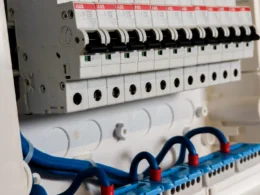 Row of circuit breaker switches in an open electrical panel, the kind of switch that takes a site offline