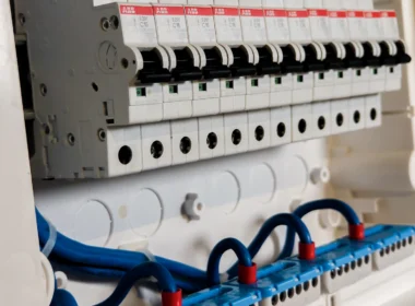 Row of circuit breaker switches in an open electrical panel, the kind of switch that takes a site offline
