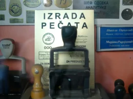 A collection of rubber stamps and plaques laid out on a desk