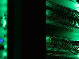 A rack of electronic server equipment in a dark room