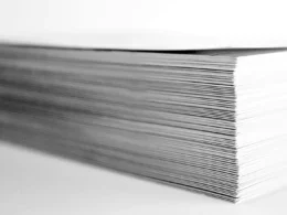 A stack of printed papers on a desk