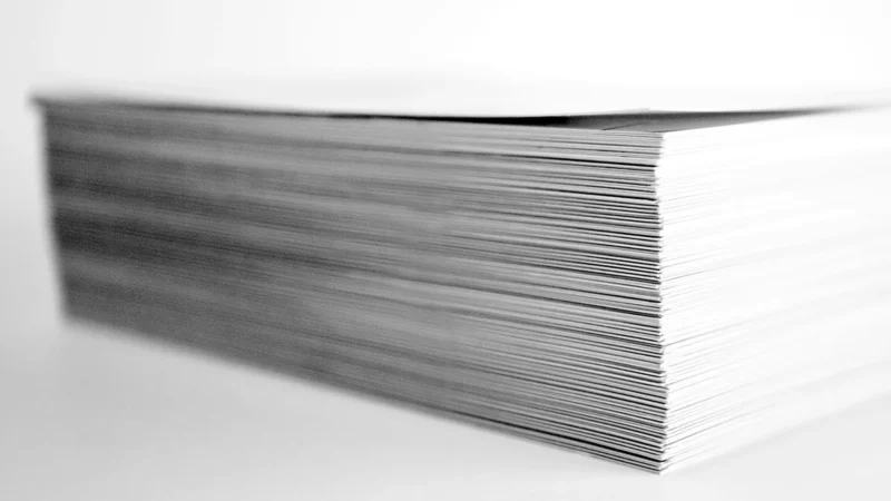 A stack of printed papers on a desk
