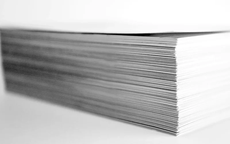 A stack of printed papers on a desk