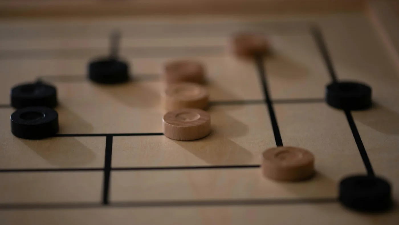 A wooden board game set up on a table