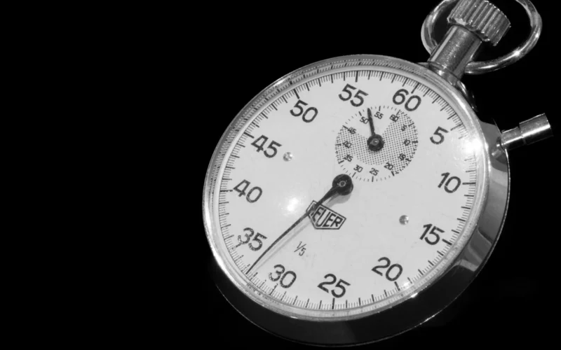 Close-up of a stopwatch against a black background