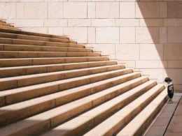 Toddler's standing in front of beige concrete stair