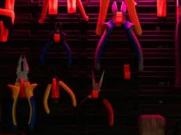Hand tools of various kinds hanging on a workshop wall