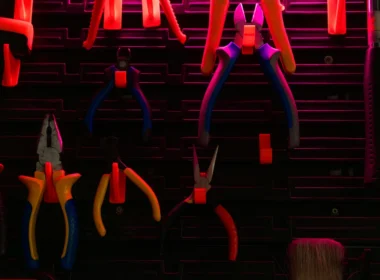 Hand tools of various kinds hanging on a workshop wall