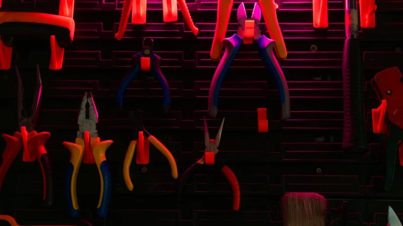 Hand tools of various kinds hanging on a workshop wall