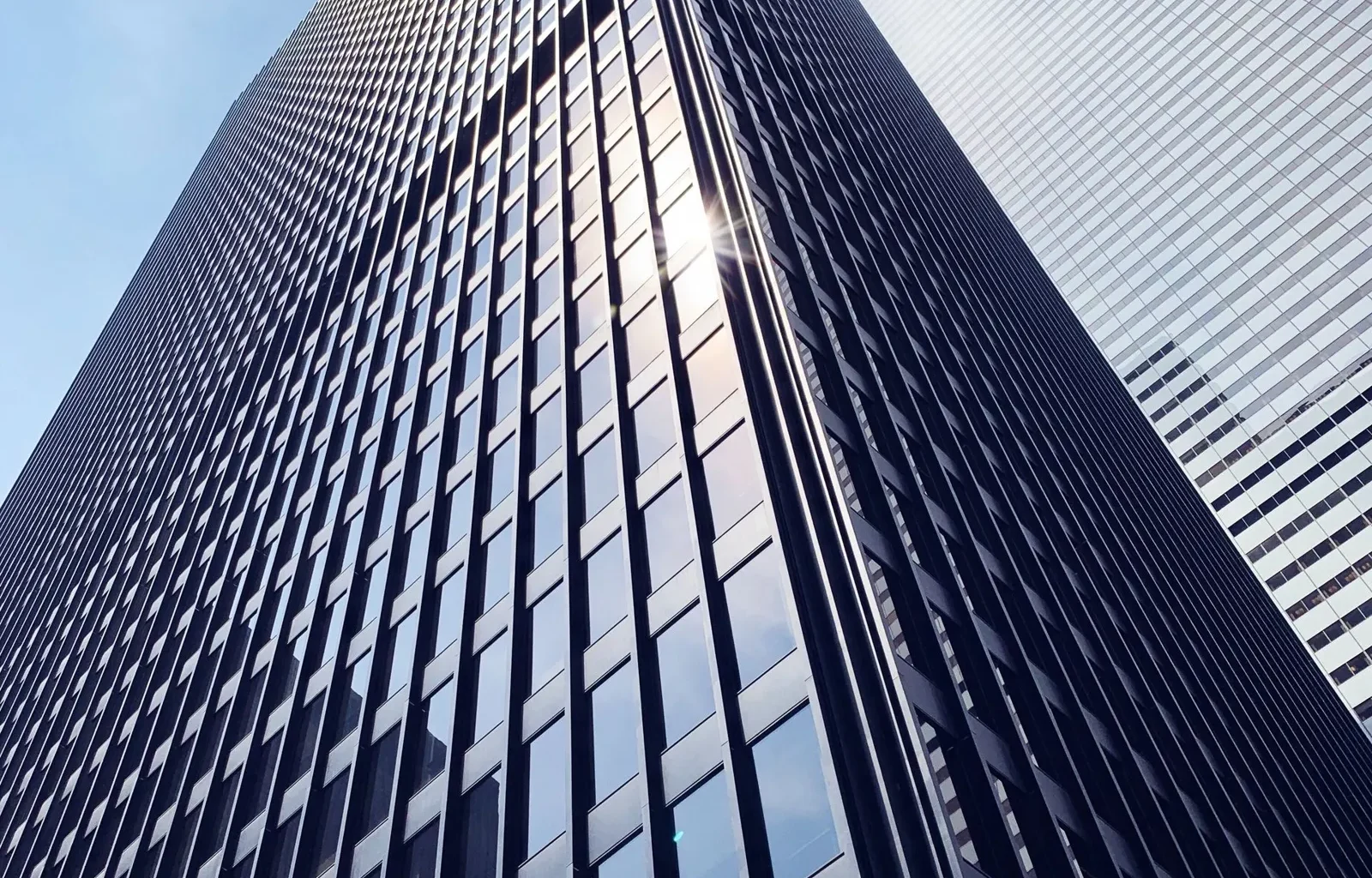 Low-angle view of a glass office tower in downtown Toronto.