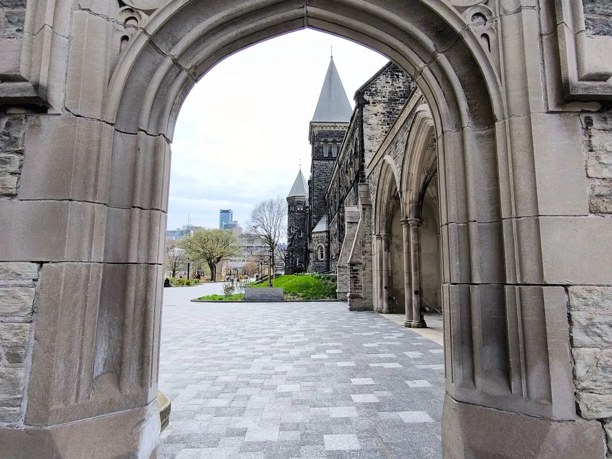 Stone archway at the University of Toronto, illustrating a column on AI in health research