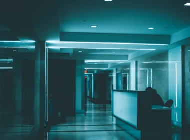 White wooden desk on hallway inside building