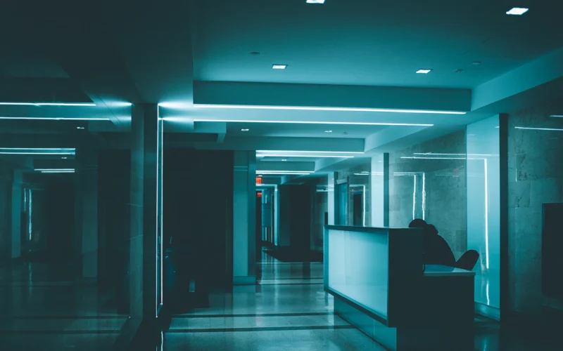 White wooden desk on hallway inside building