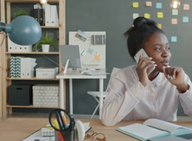 Woman talking on the phone at a desk in an office