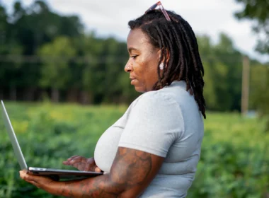 Woman using a laptop in a field