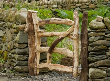 A wooden gate in front of a stone wall