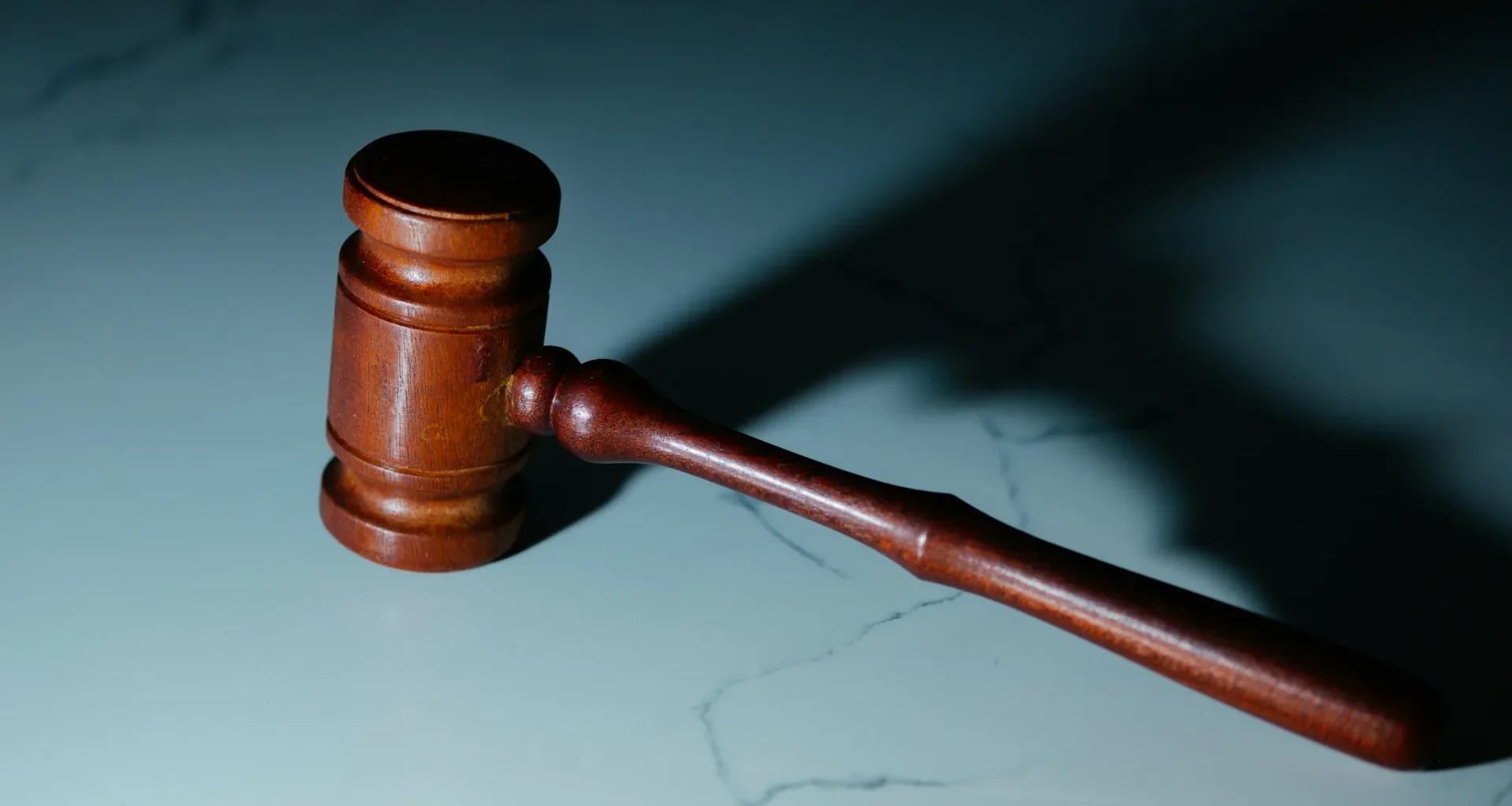 A wooden judge's gavel resting on a table