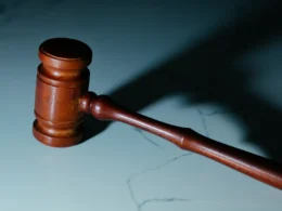 A wooden judge's gavel resting on a table