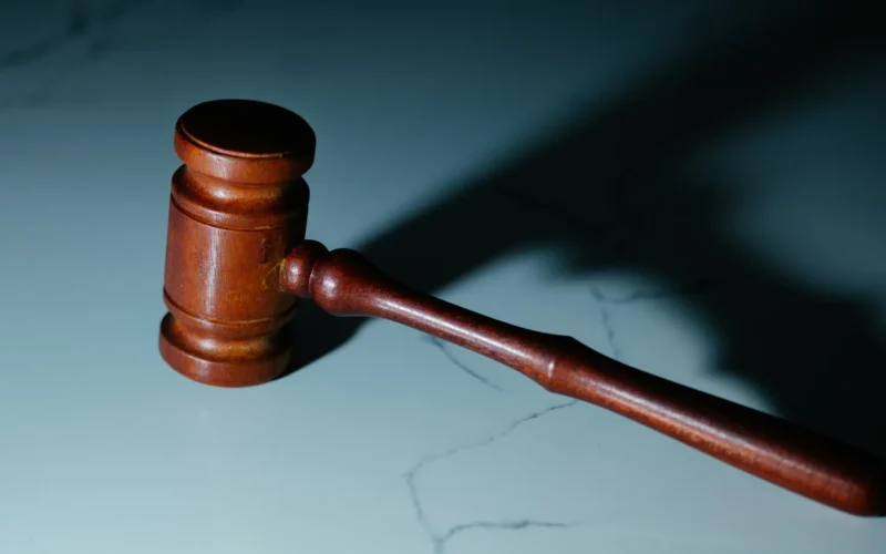 A wooden judge's gavel resting on a table