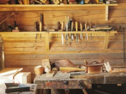 A workbench in a wooden cabin with lots of tools
