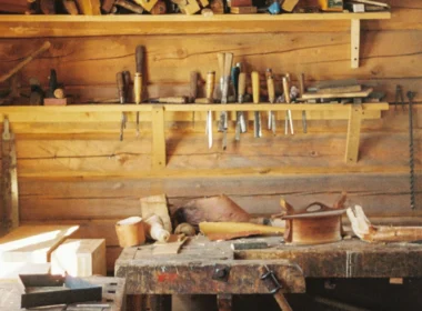 A workbench in a wooden cabin with lots of tools