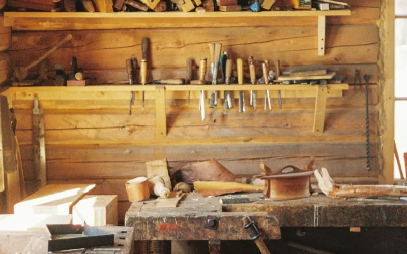 A workbench in a wooden cabin with lots of tools