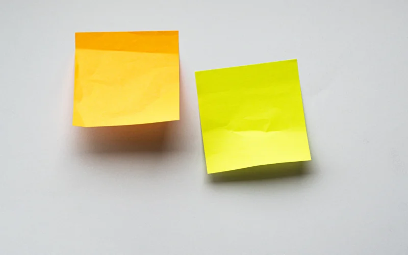 Yellow sticky notes on white wall